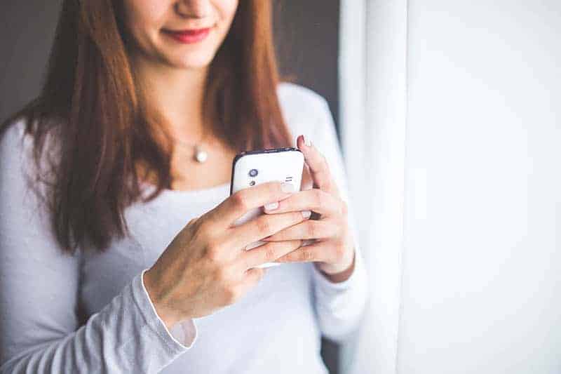woman typing on her phone
