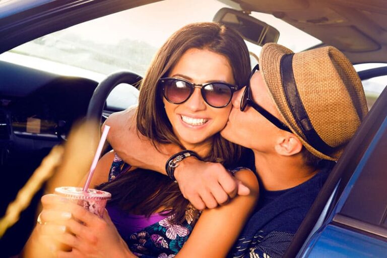 young man kissing a woman in the car