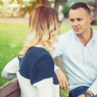 couple sitting on bench talking