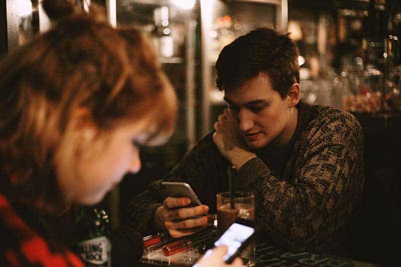 boring couple using their smartphones