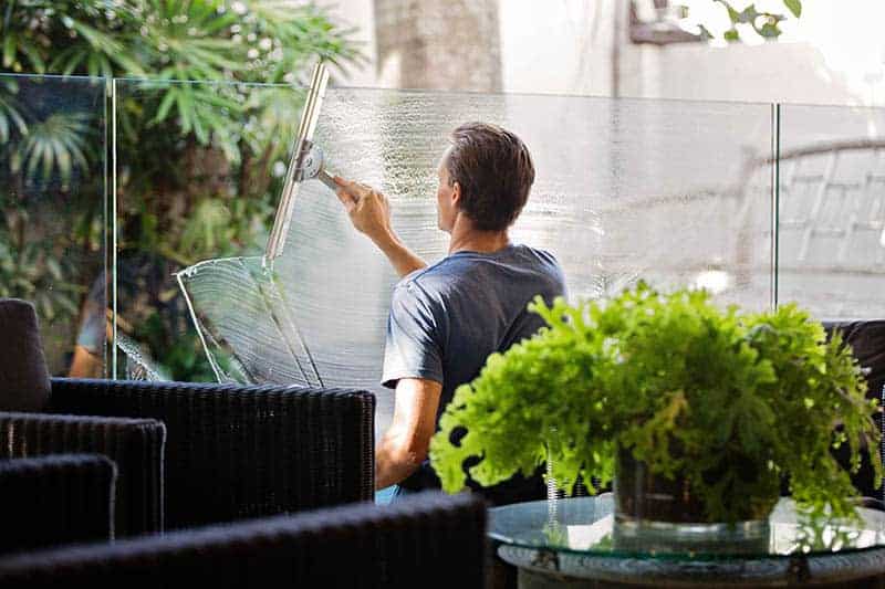 man cleaning window in cafe