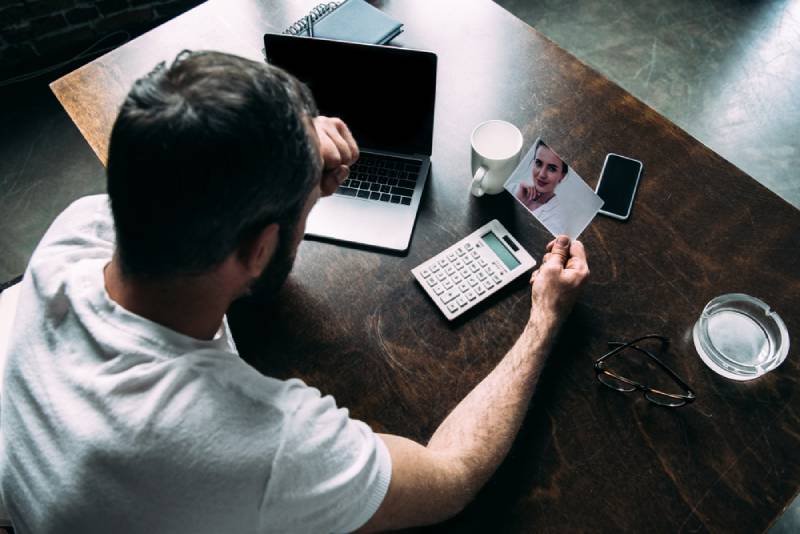 man looking at photo of ex-girlfriend