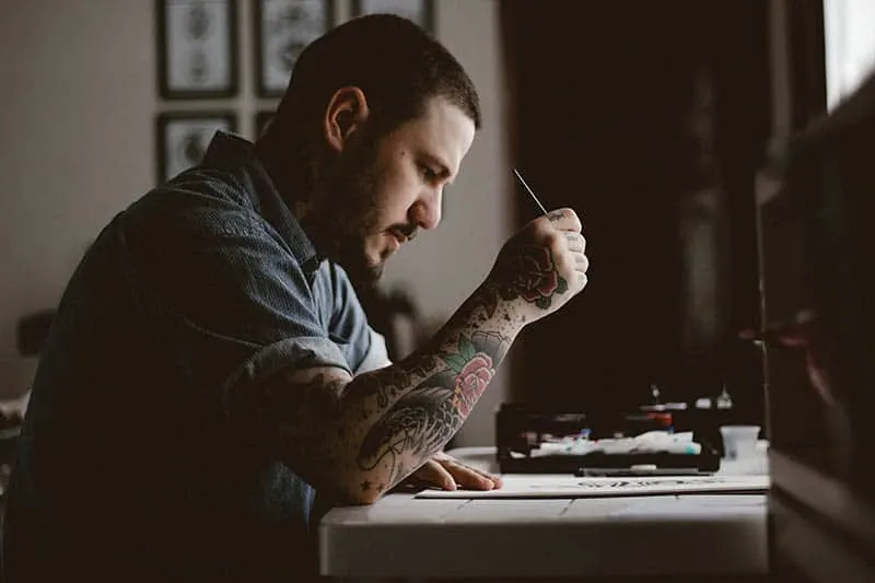 man writing something down