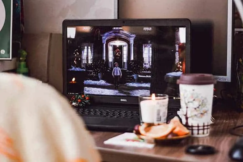 photo of laptop beside candles