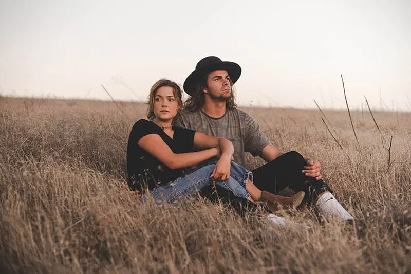 serious couple on field