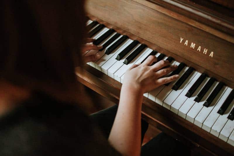 woman playing on yamaha piano