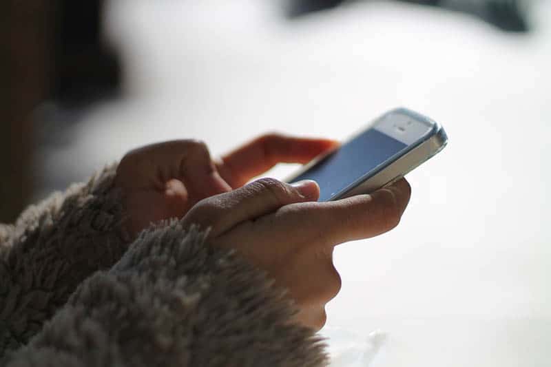 close up photo of persons typing on his phone