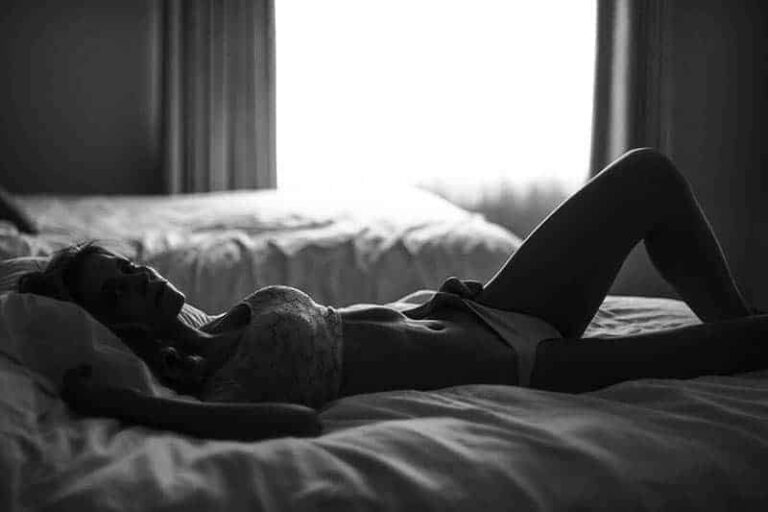 woman in underwear lying on bed
