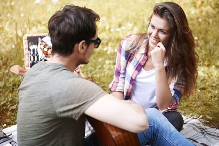 smiling woman talking to man