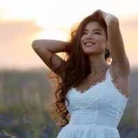 happy attractive woman standing in the field