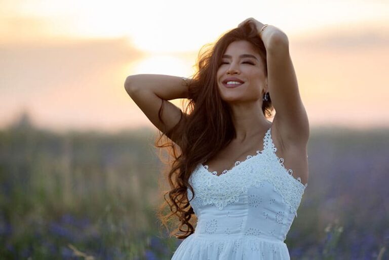 happy attractive woman standing in the field