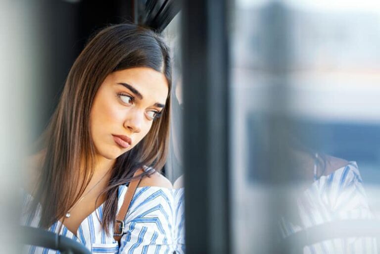 sad woman looking through the window