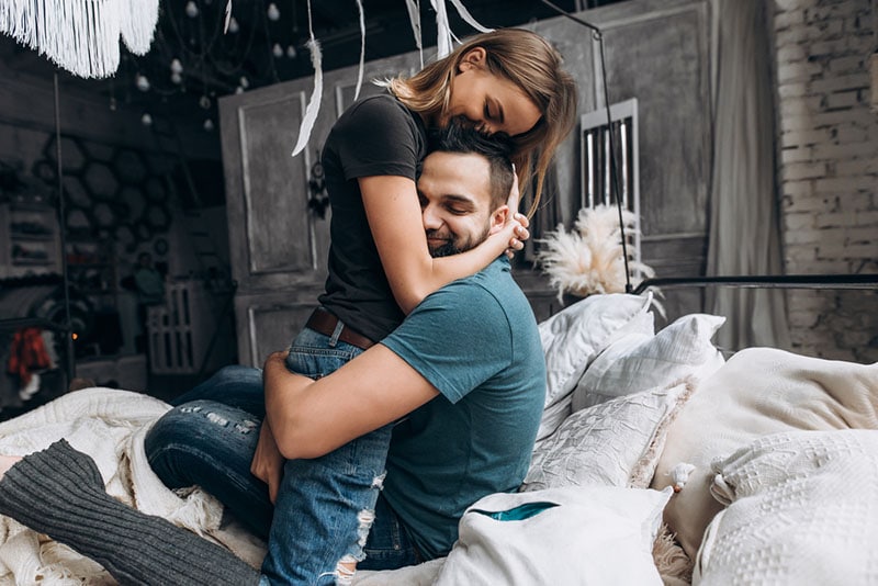 couple hugging on bed