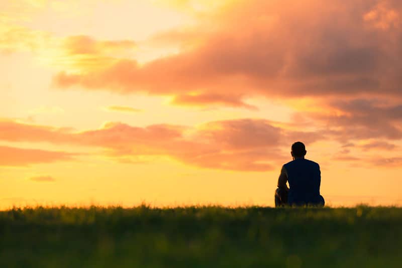 man watching sunset