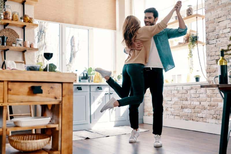 romantic couple dancing in the kitchen