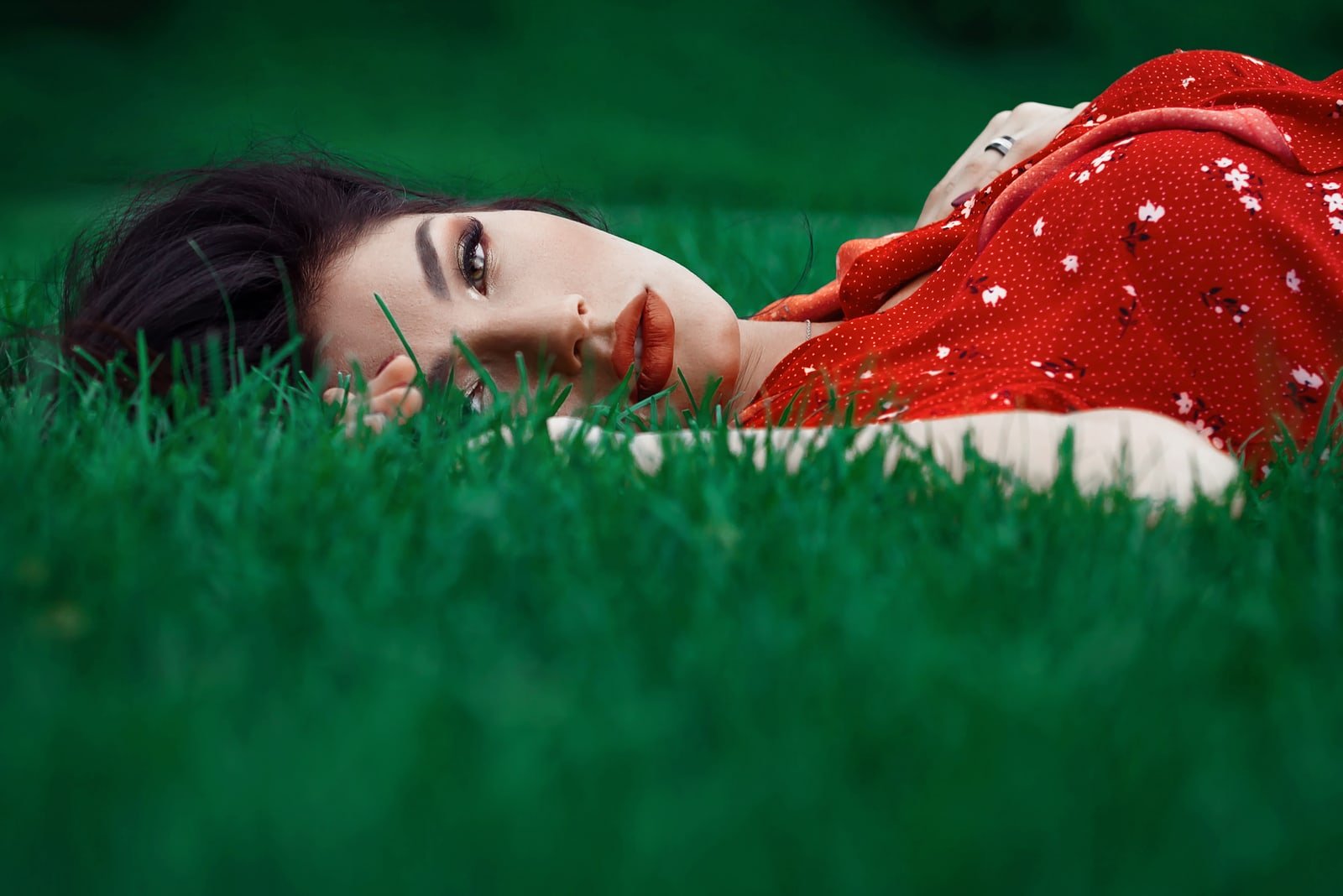 the woman lies on the grass