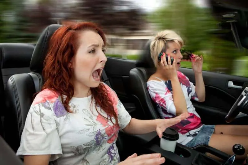 two females looks scary driving in car
