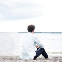 mindful man sitting on the beach