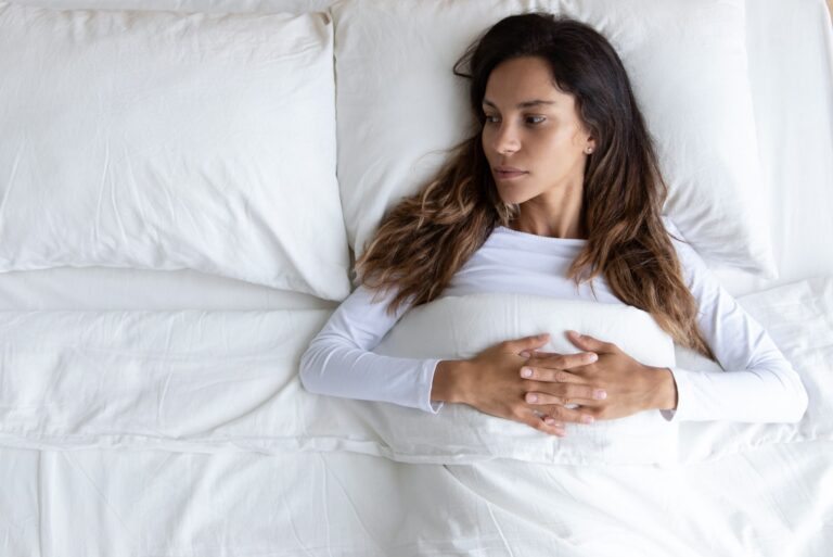 worried woman lying in bed