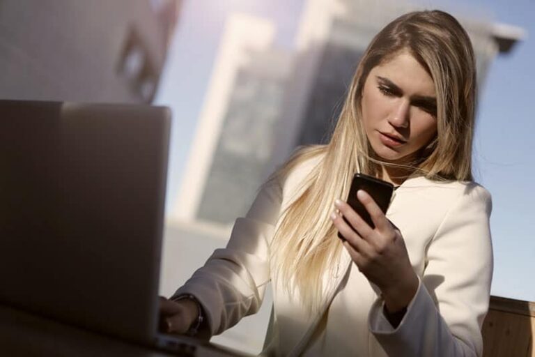 serious woman looking at phone