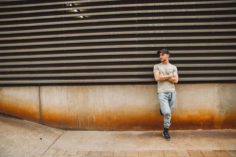 man leaning on wall outside