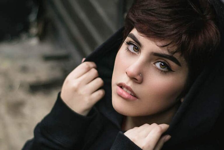 thoughtful woman wearing hoodie outside