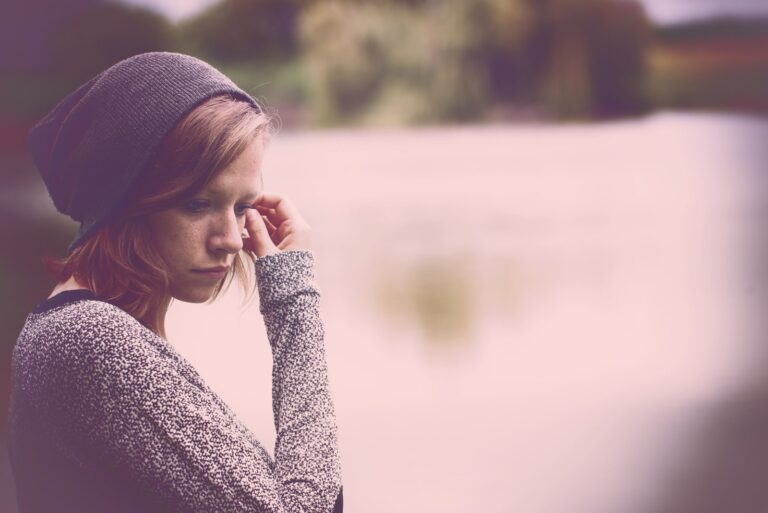 a portrait of a sad woman outside