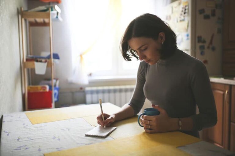 sad woman writing a letter