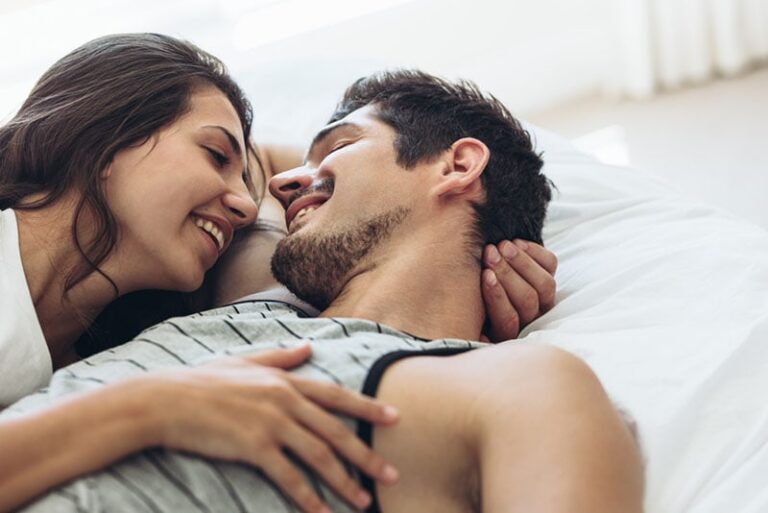 happy couple lying on the bed