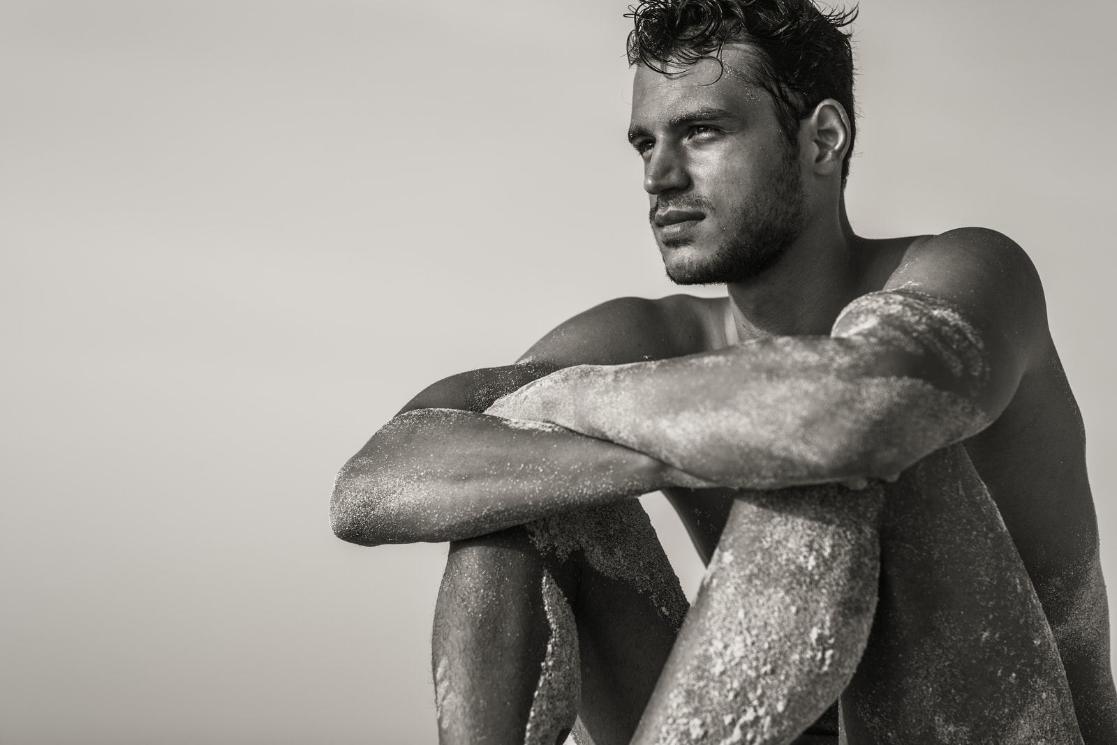 handsome man sitting on the beach