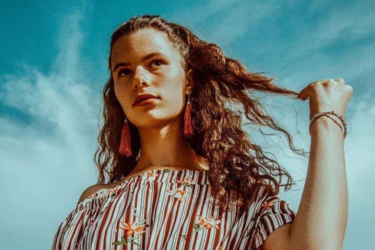 woman touching her curly hair