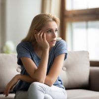 serious woman sitting on the couch