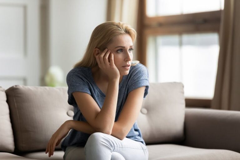 serious woman sitting on the couch