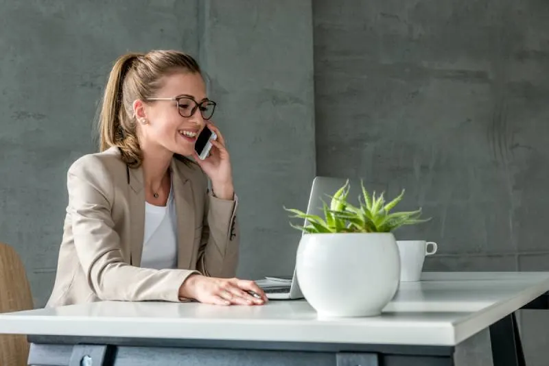 business woman having a call while sitting at desk