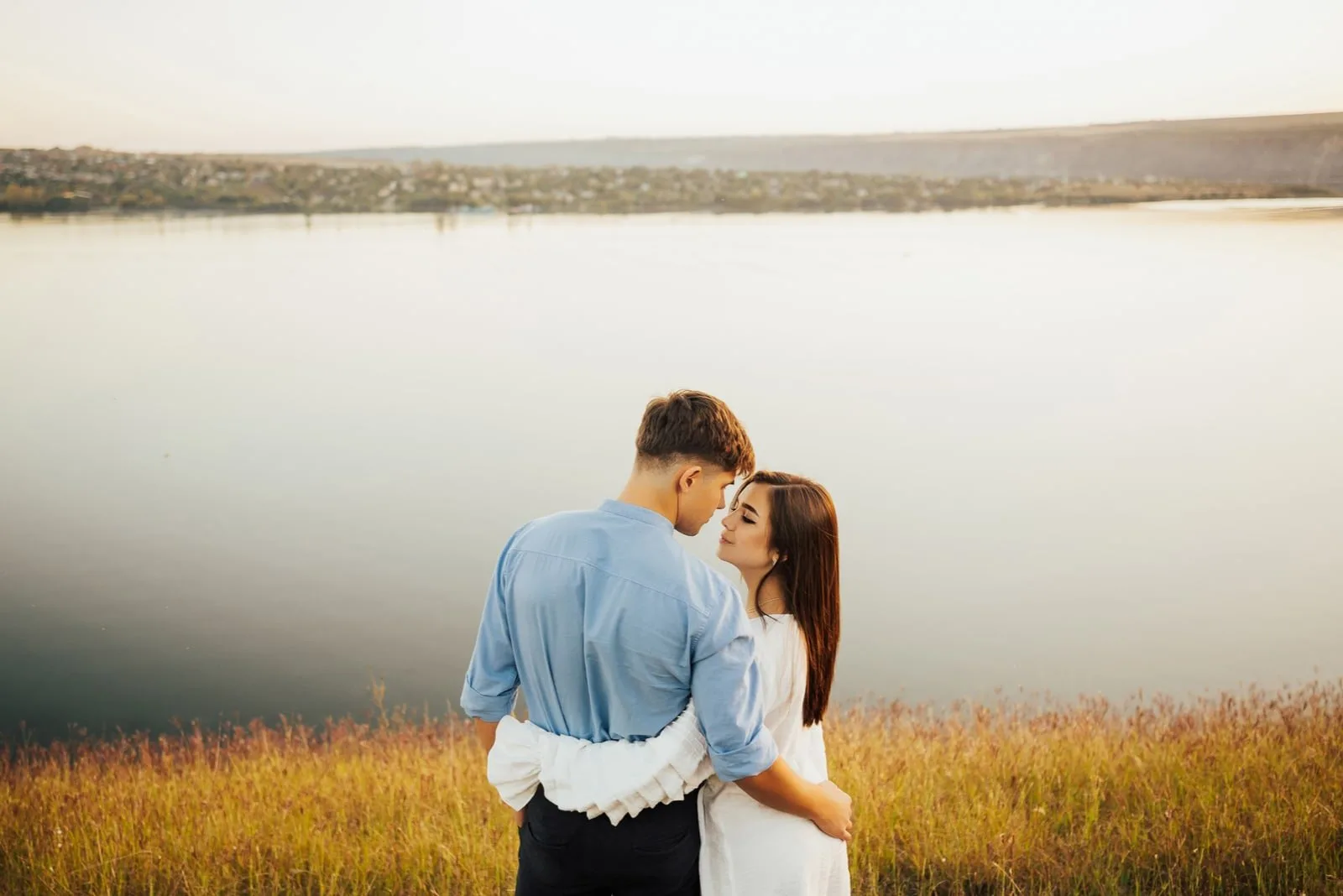 couple standing by the lake