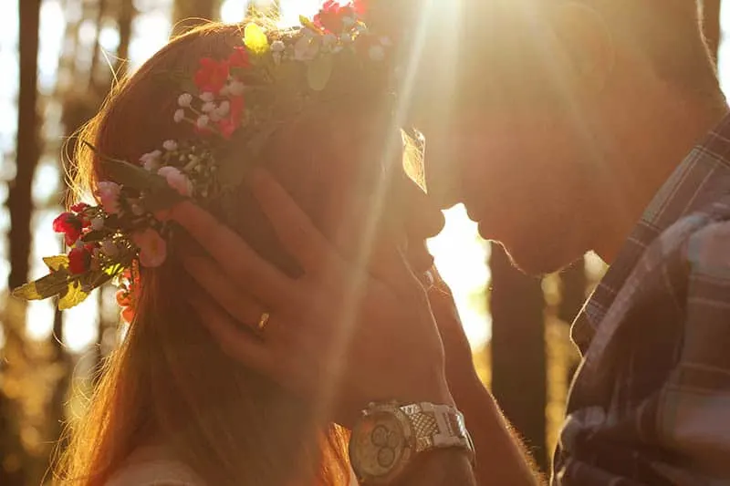man holds woman face outside