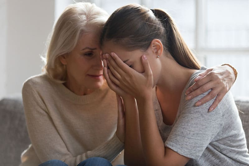 mother comforting her daughter