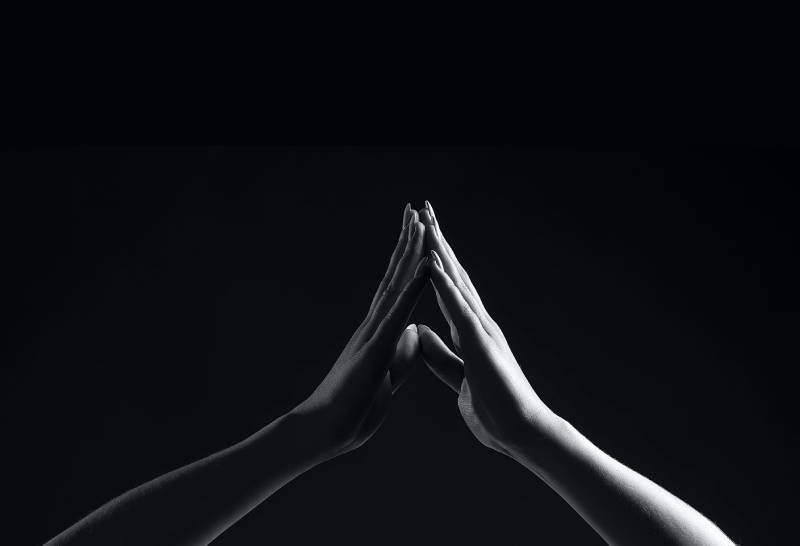 person's hands forming triangle