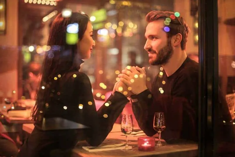 romantic couple looking each other while having a dinner in restaurant