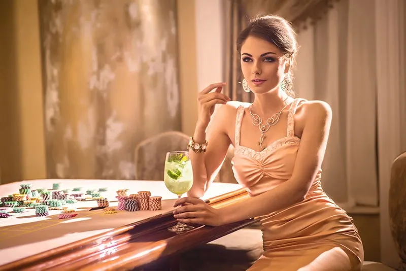 sexy woman sitting by casino desk