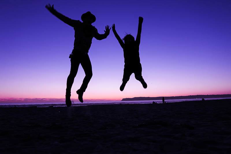 silhouette of persons jumping