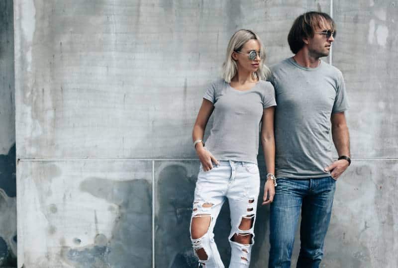 two hipster in grey tshirt standing in front of wall