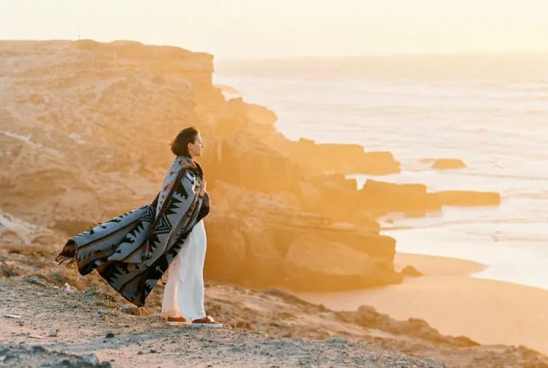 woman standing on cliff edge