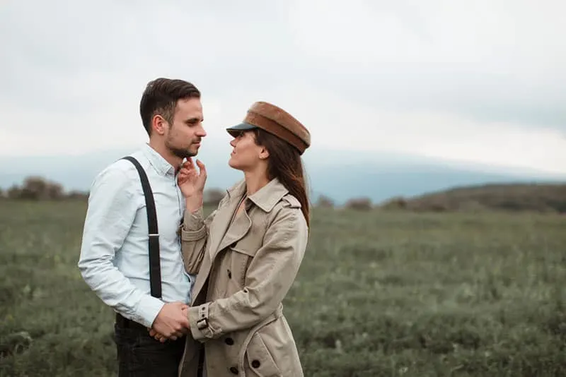 woman with hat cuddling her husband outdoor