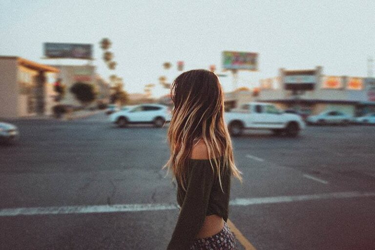 side view of woman walking on the street
