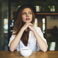 serious woman with hat looking away