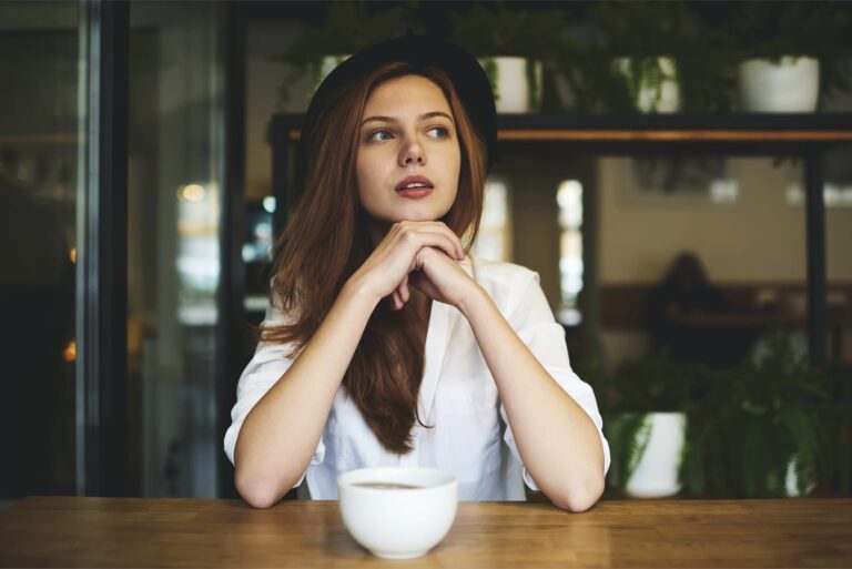 serious woman with hat looking away