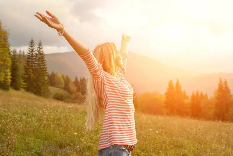 Happiness woman stay outside under sunlight of sunset