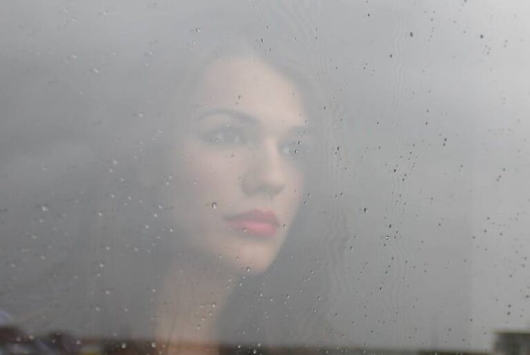 woman looking through window