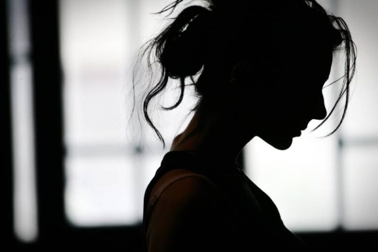 silhouette o sad woman at home